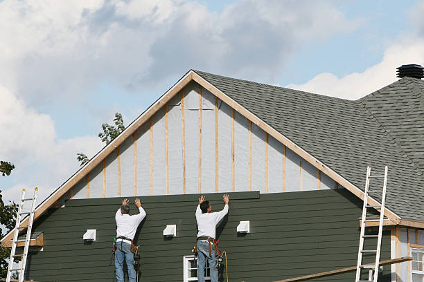 Professional Storm Damage Siding Repair technician working in Boston, IN